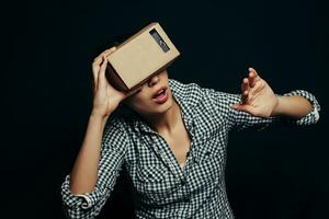 Color shot of a young woman looking through cardboard photo