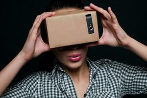 Color shot of a young woman looking through  cardboard photo