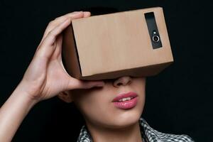 Color shot of a young woman looking through  cardboard photo