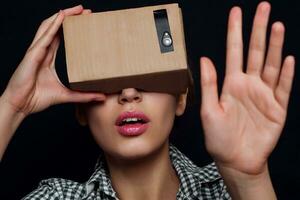 Color shot of a young woman looking through cardboard photo