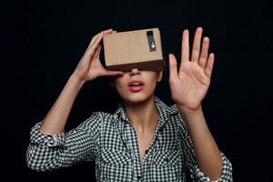 Color shot of a young woman looking through cardboard photo