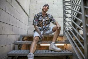 young caucasian tattooed singer rap posing photo