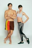 Young sportsmen couple woman and man in studio on white background photo