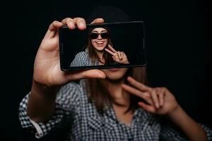 Hipster girl taking picture smartphone self-portrait, screen view photo