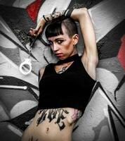 Rebel tattooed girl shows handcuffs photo