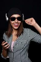 happy listening music with big headphones  phone or player photo