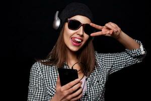 happy listening music with big headphones  phone or player photo