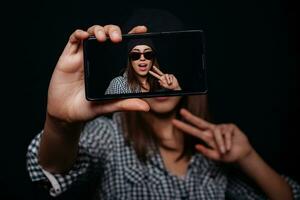 Hipster girl taking picture smartphone self-portrait, screen view photo