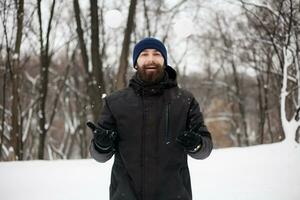 bearded guy playing snowballs photo