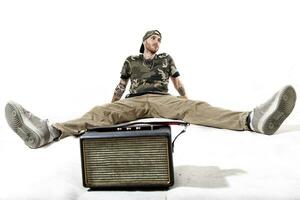 sitting tattooed rap singer posing in studio photo