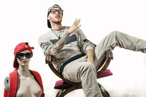 tattooed rap singer posing in studio with a female dummy photo