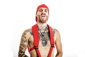 tattooed rap singer posing in studio on a white background photo
