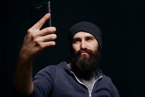 Beautiful young man with a beard  makes self photo