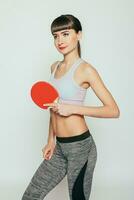 Young woman holding a table tennis racket photo