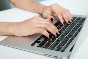 Closeup portrait of woman hand typing on computer keyboard photo