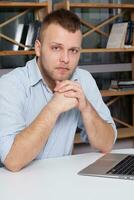 Hipster businessman working at his desk office photo