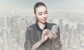 Double exposure of city and beautiful business woman folded her arms photo