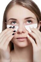 Woman using cotton pad photo