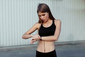 Female runner taking rest after workout in the city. photo