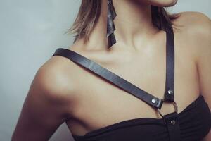 body girl dressed in  black leather sword belt photo