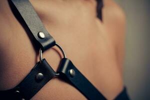 body girl dressed in  black leather sword belt photo