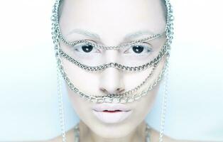 girl with chain on her face in white photo