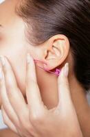 Close up image of female ear with earring photo