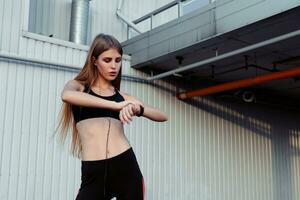 Female runner taking rest after workout in the city. photo