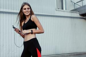 Female runner taking rest after workout in the city. photo