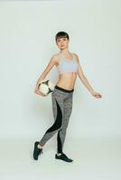 Young and sexy girl with soccer ball over white background photo