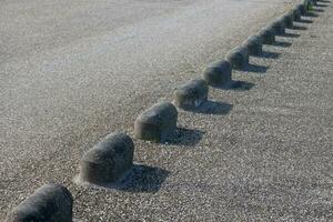 concrete barriers on an asphalt road photo