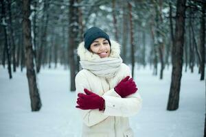 Winter woman blowing snow in a park photo