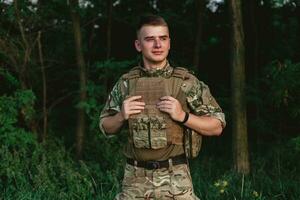 Soldier man standing against a field photo