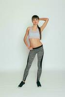 Fitness model in gray sportswear. Healthy lifestyle. photo