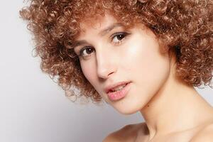 Portrait of smiling young woman with afro hairstyle photo