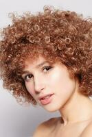 Portrait of smiling young woman with afro hairstyle photo