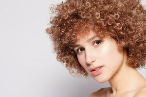 Portrait of smiling young woman with afro hairstyle photo