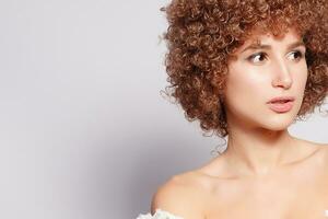 Portrait of smiling young woman with afro hairstyle photo