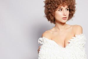 Portrait of smiling young woman with afro hairstyle photo