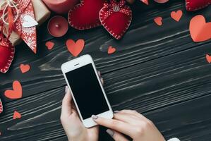 Valentines day concept. Hand make yarn red heart beside wooden block calendar set on Valentines date 14 February on table and bright room background. Happy valentine day. photo