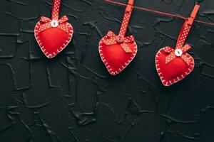 Valentines day concept. Hand make yarn red heart beside wooden block calendar set on Valentines date 14 February on table and bright room background. Happy valentine day. photo