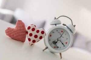 Valentines day concept. Hand make yarn red heart beside wooden block calendar set on Valentines date 14 February on table and bright room background. Happy valentine day. photo