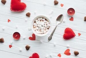 Valentines day concept. Hand make yarn red heart beside wooden block calendar set on Valentines date 14 February on table and bright room background. Happy valentine day. photo