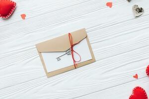 Valentines day concept. Hand make yarn red heart beside wooden block calendar set on Valentines date 14 February on table and bright room background. Happy valentine day. photo