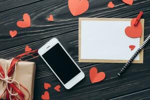 Valentines day concept. Hand make yarn red heart beside wooden block calendar set on Valentines date 14 February on table and bright room background. Happy valentine day. photo