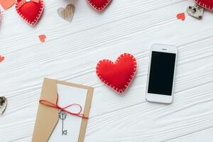 Valentines day concept. Hand make yarn red heart beside wooden block calendar set on Valentines date 14 February on table and bright room background. Happy valentine day. photo