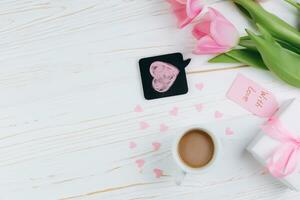 Valentines day concept. Hand make yarn red heart beside wooden block calendar set on Valentines date 14 February on table and bright room background. Happy valentine day. photo