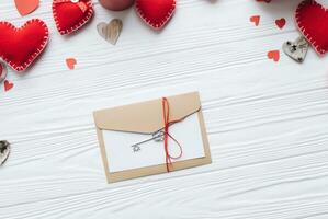 Valentines day concept. Hand make yarn red heart beside wooden block calendar set on Valentines date 14 February on table and bright room background. Happy valentine day. photo