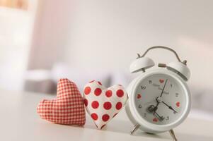 Valentines day concept. Hand make yarn red heart beside wooden block calendar set on Valentines date 14 February on table and bright room background. Happy valentine day. photo