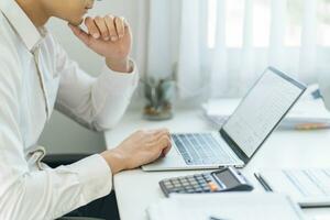 Business man working using laptop computer Hands typing keyboard. Professional investor working start up project. business planning in office. Technology business Concept photo